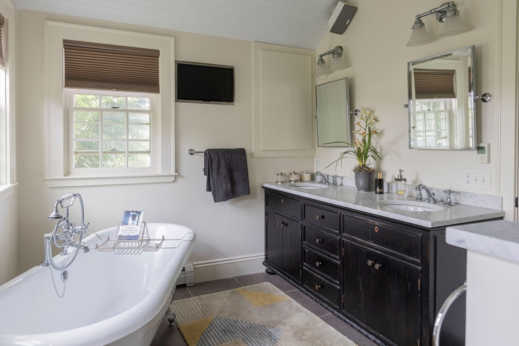 7 Waldron Court Marblehead, MA 01945 - Photo 13 of 26 a bathroom with a tub sink and mirror
