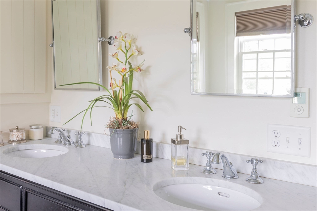 7 Waldron Court Marblehead, MA 01945 - Photo 14 of 26 a bathroom with a sink and a mirror