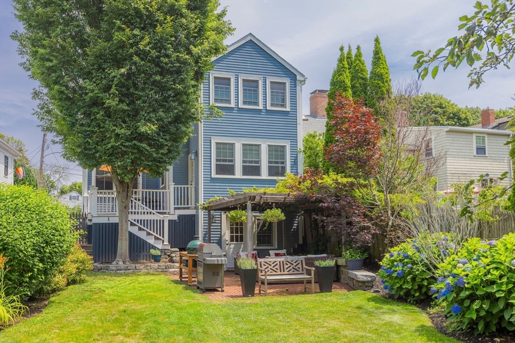 7 Waldron Court Marblehead, MA 01945 - Photo 22 of 26 a backyard of a house with yard and outdoor seating