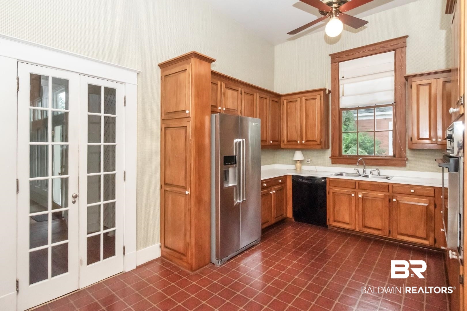 959 Dauphin Street Mobile, AL 36604 - Photo 12 of 43 Kitchen with high end fridge, sink, black dishwasher, and dark tile patterned floors