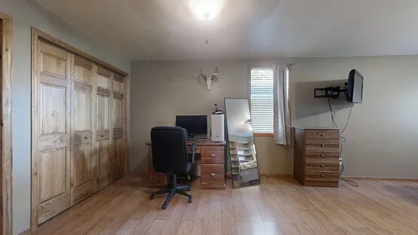 a view of a workspace with furniture and wooden floor