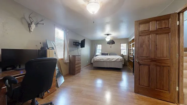 a bedroom with bed and window