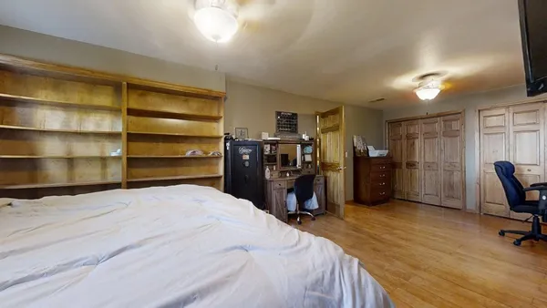 a bed room with a bed and a television