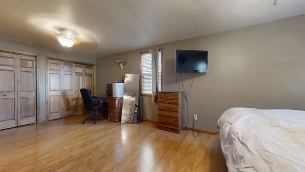 a bedroom with furniture and a flat screen tv