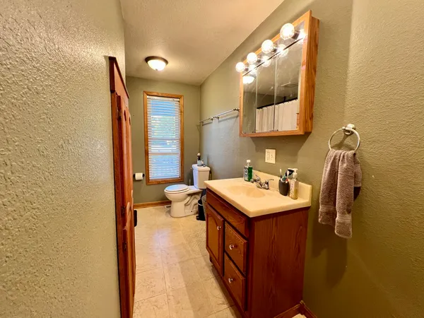 a bathroom with a sink toilet and mirror