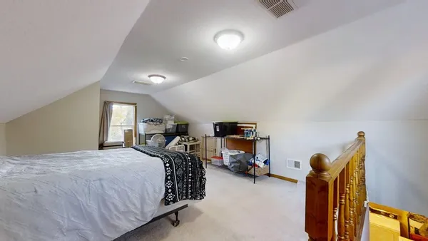 a bedroom with furniture and a window