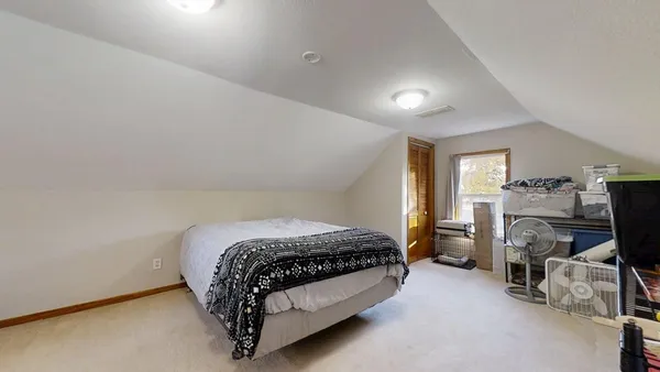 a bed sitting in a room next to a window