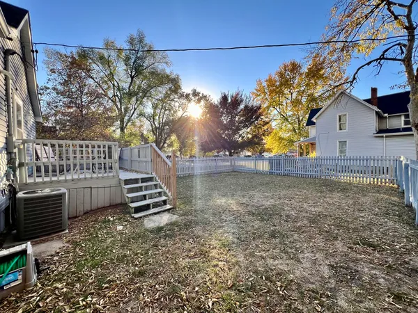 a view of a yard with wooden fence