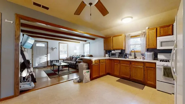 a kitchen with cabinets a sink and appliances
