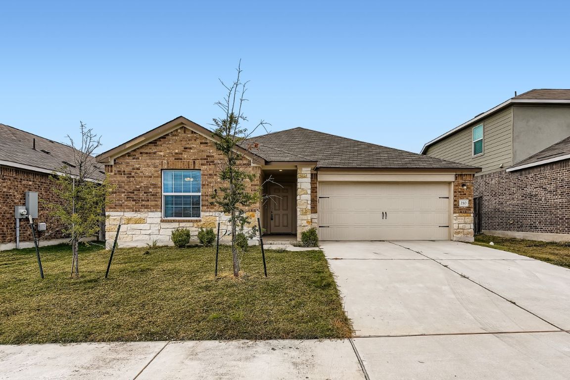 210 Montego Street Hutto, TX 78634 - Photo 1 of 29 a front view of a house with a yard