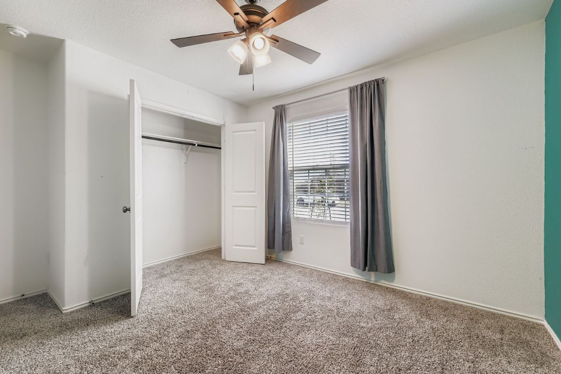 210 Montego Street Hutto, TX 78634 - Photo 19 of 29 an empty room with windows and fan