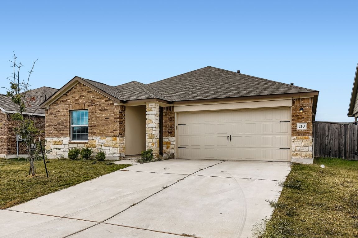 210 Montego Street Hutto, TX 78634 - Photo 2 of 29 front view of a house with a yard