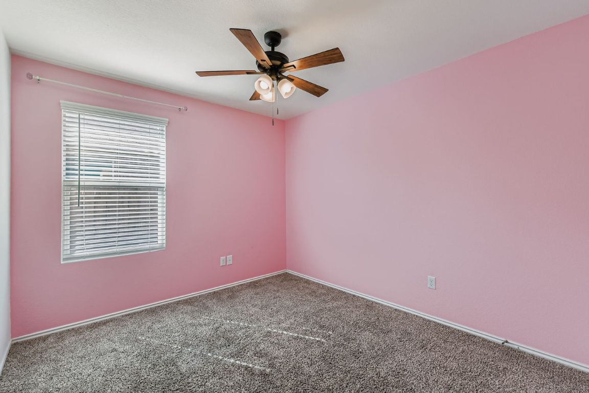210 Montego Street Hutto, TX 78634 - Photo 21 of 29 a view of a livingroom with a ceiling fan and window