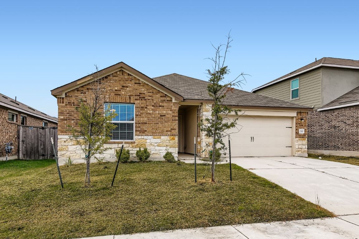 210 Montego Street Hutto, TX 78634 - Photo 3 of 29 a front view of a house with a yard