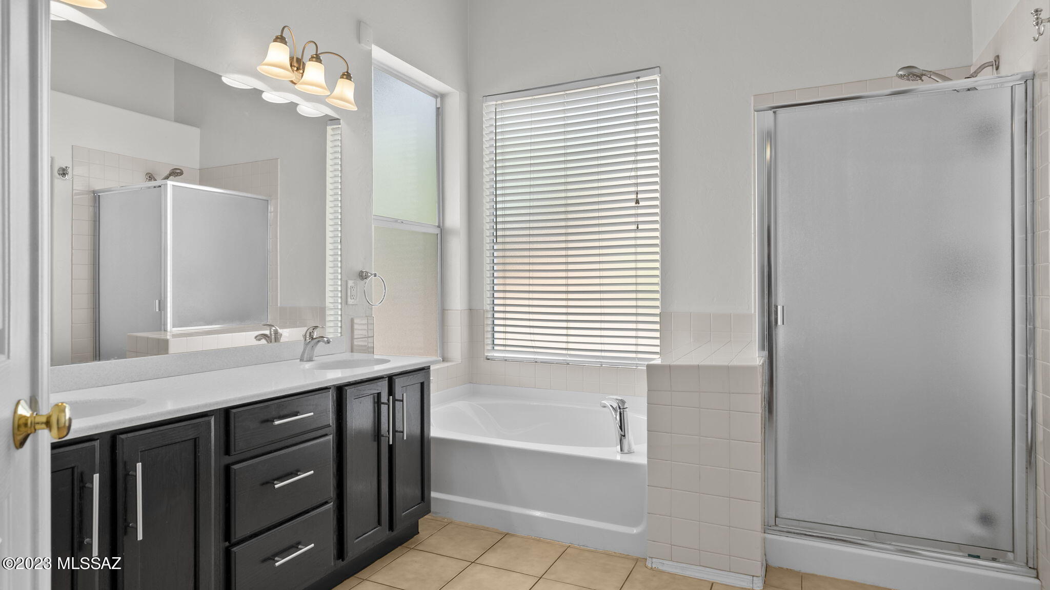 401 Via Capri Rio Rico, AZ 85648 - Photo 27 of 38 a bathroom with a double vanity sink and a mirror