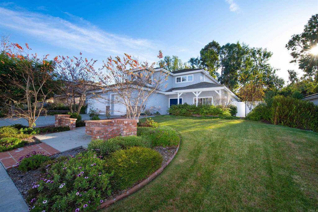 a aerial view of a house with a yard table and chairs