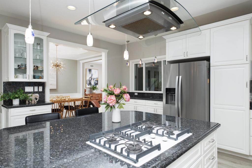 1677 Mission Meadow Drive Oceanside, CA 92057 - Photo 11 of 48 a large kitchen with a table and chairs