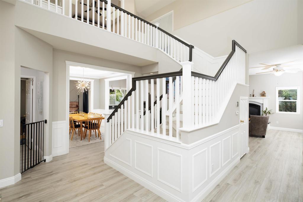 1677 Mission Meadow Drive Oceanside, CA 92057 - Photo 16 of 48 a view of staircase with white walls and a chandelier