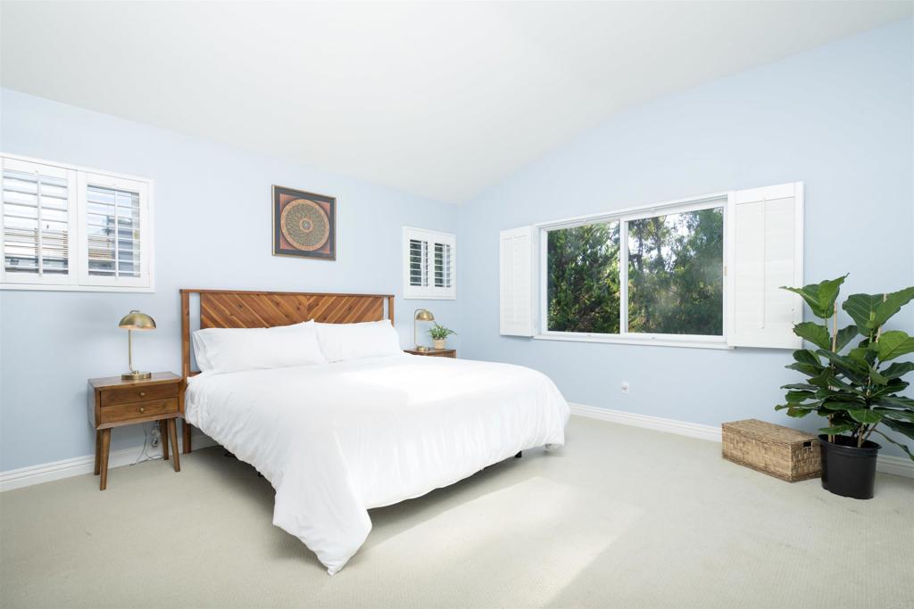 1677 Mission Meadow Drive Oceanside, CA 92057 - Photo 17 of 48 a bedroom with a bed and a potted plant