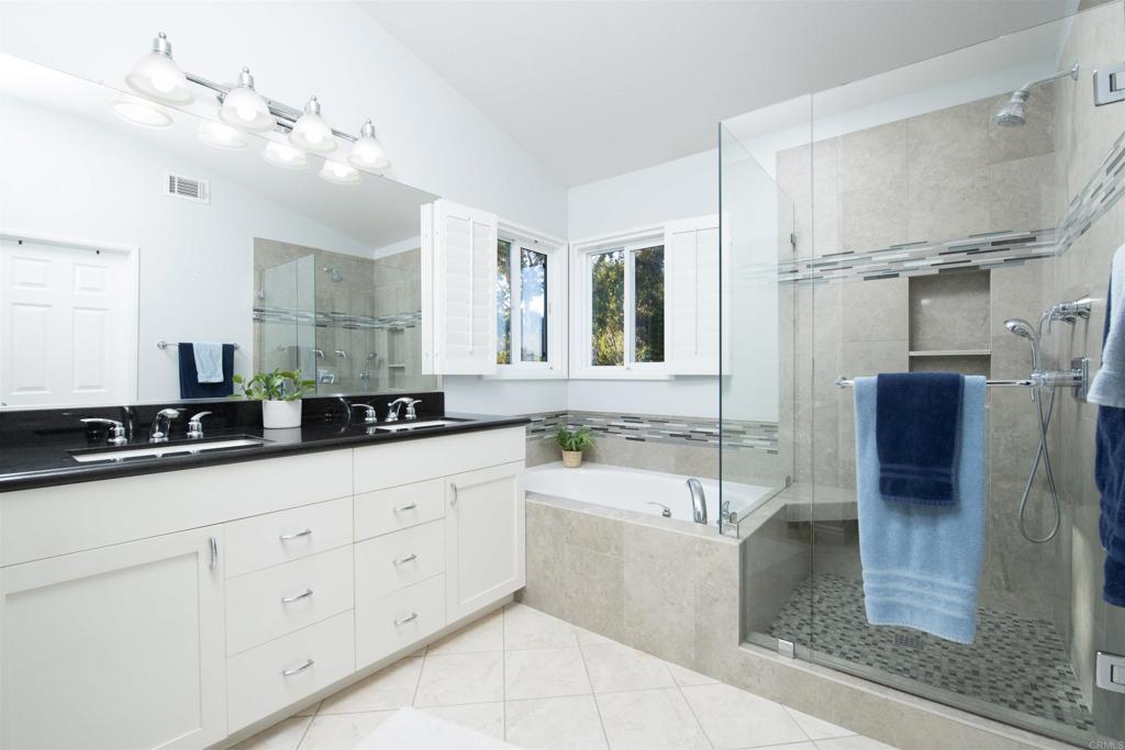 1677 Mission Meadow Drive Oceanside, CA 92057 - Photo 18 of 48 a bathroom with a tub sink and mirror