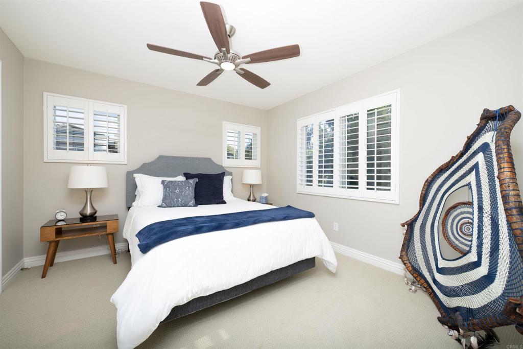 1677 Mission Meadow Drive Oceanside, CA 92057 - Photo 20 of 48 a bedroom with a bed and a chandelier