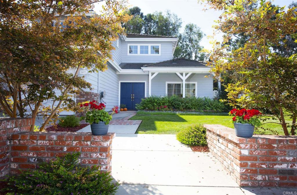 1677 Mission Meadow Drive Oceanside, CA 92057 - Photo 2 of 48 a front view of a house with a yard and fountain