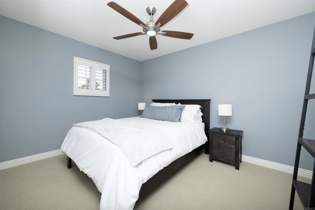 1677 Mission Meadow Drive Oceanside, CA 92057 - Photo 21 of 48 a bedroom with a bed and window
