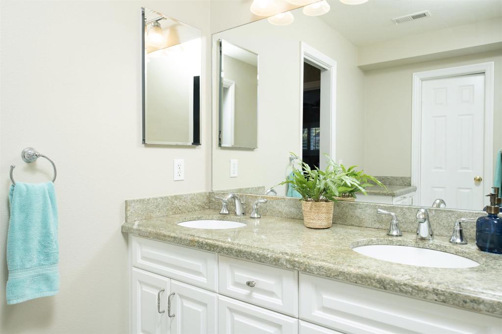 1677 Mission Meadow Drive Oceanside, CA 92057 - Photo 22 of 48 a bathroom with a granite countertop sink and a mirror