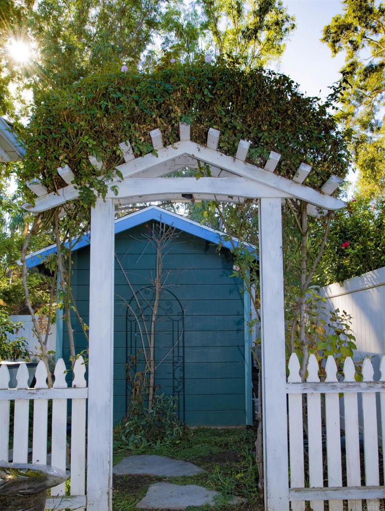 1677 Mission Meadow Drive Oceanside, CA 92057 - Photo 32 of 48 a view of a wooden house with a small yard