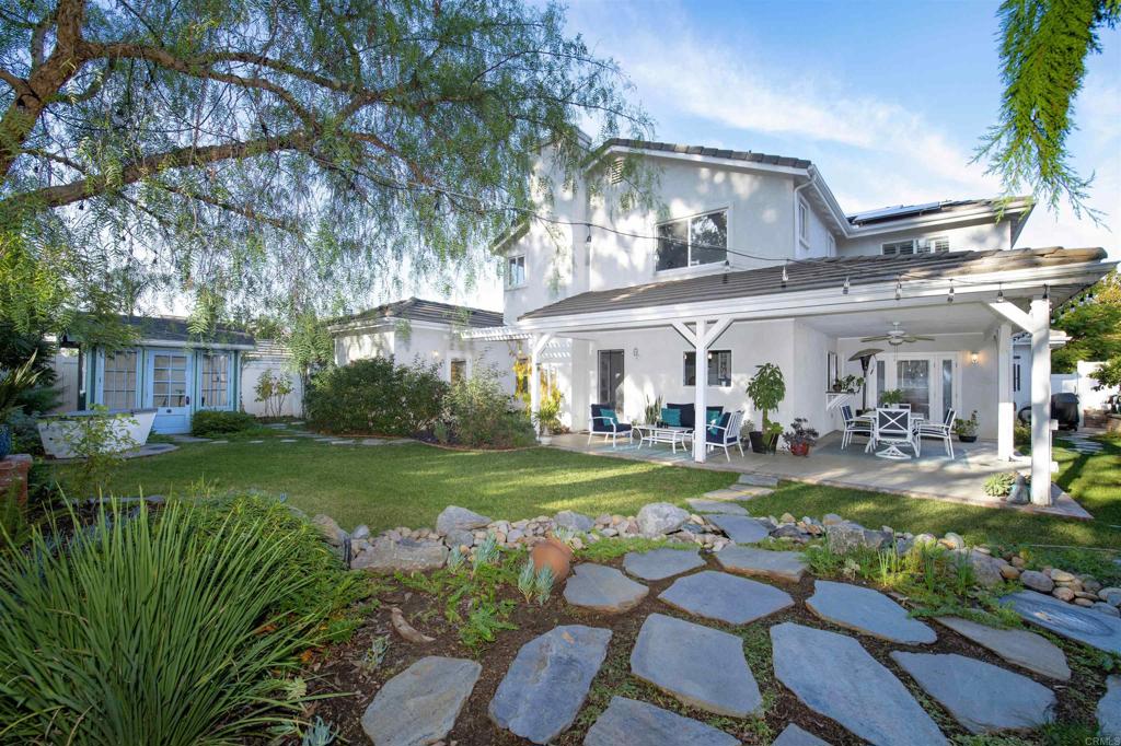 1677 Mission Meadow Drive Oceanside, CA 92057 - Photo 35 of 48 a front view of a house with garden and outdoor seating