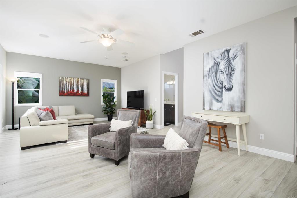 1677 Mission Meadow Drive Oceanside, CA 92057 - Photo 8 of 48 a living room with furniture and wooden floor