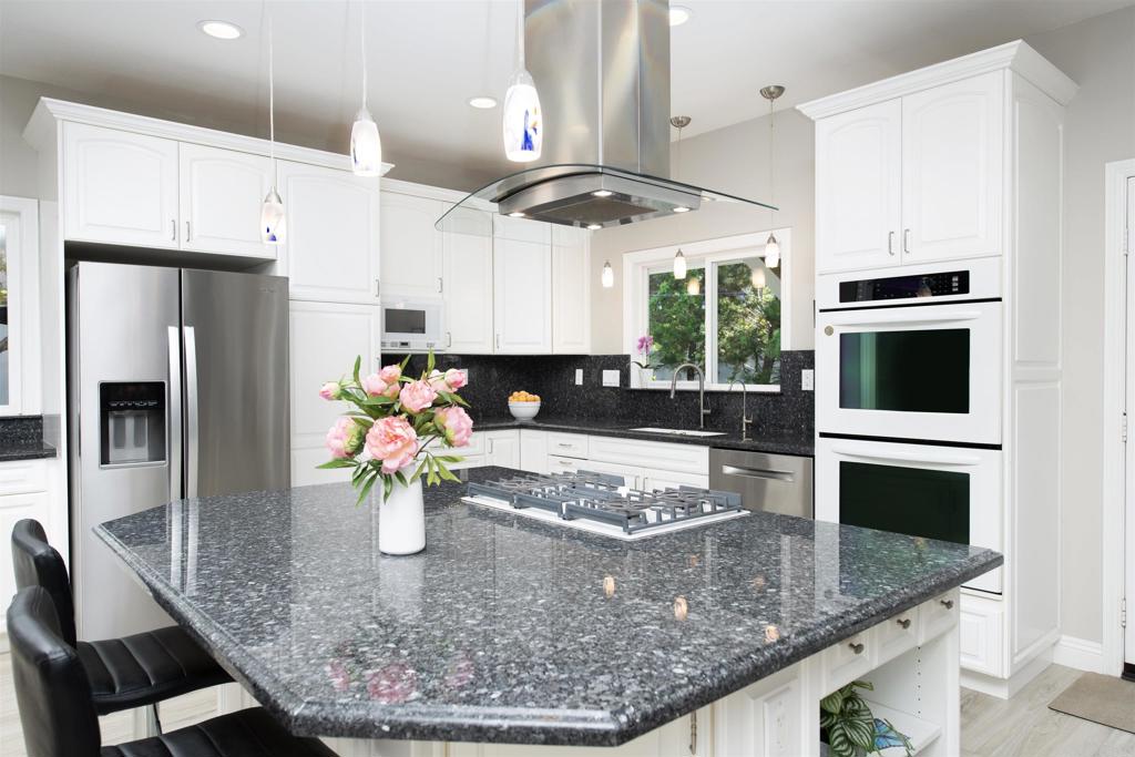 1677 Mission Meadow Drive Oceanside, CA 92057 - Photo 10 of 48 a kitchen with stainless steel appliances granite countertop a sink a stove and a refrigerator