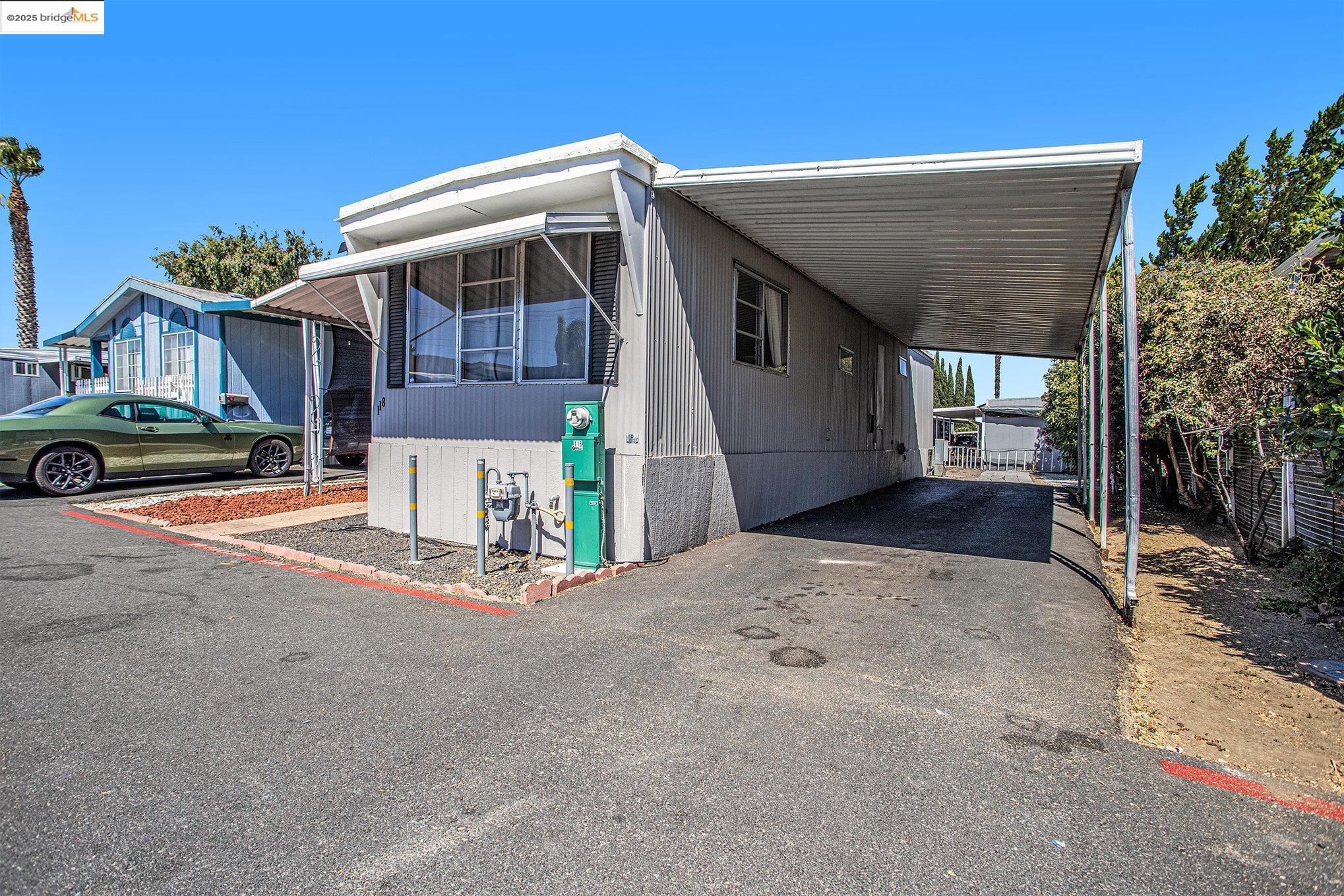 3301 Buchanan Road, Unit 118 Antioch, CA 94509 - Photo 15 of 15 Manufactured / mobile home with an attached carport and asphalt driveway