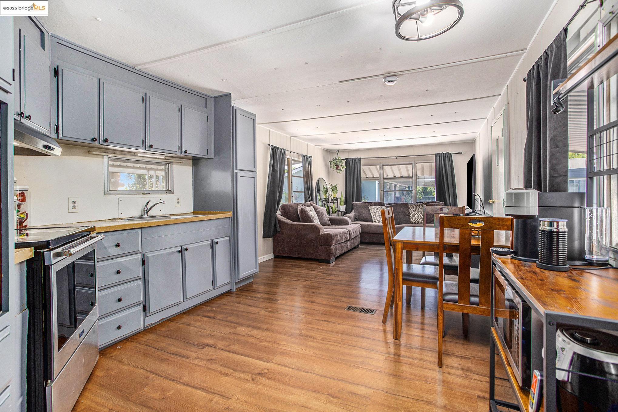 3301 Buchanan Road, Unit 118 Antioch, CA 94509 - Photo 7 of 15 Kitchen featuring gray cabinets, stainless steel appliances, wood counters, light wood finished floors, and plenty of natural light