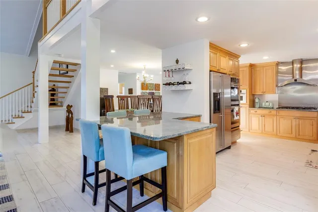 a vase with flowers on a table in front of a window