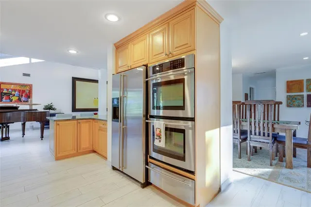 a kitchen with stainless steel appliances granite countertop a sink a stove and cabinets