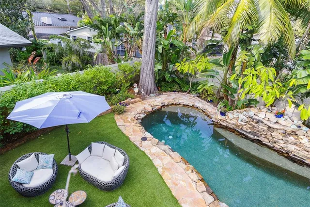 a view of a house with swimming pool and sitting area