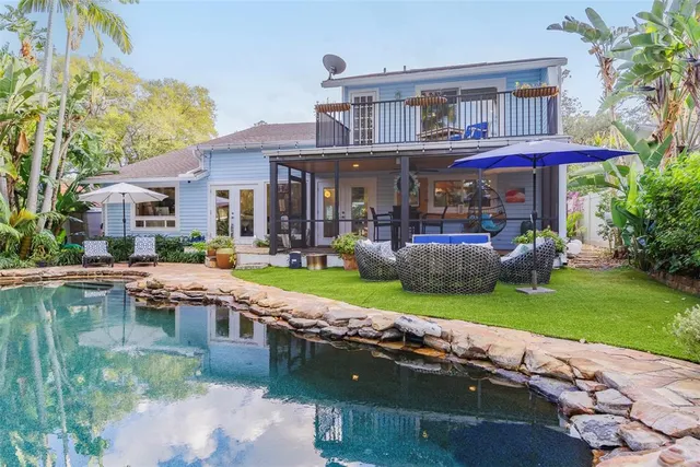 a front view of a house with porch and sitting area