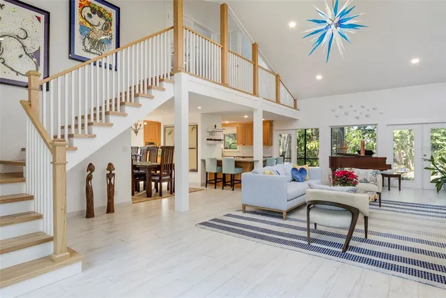 a living room with furniture and a chandelier