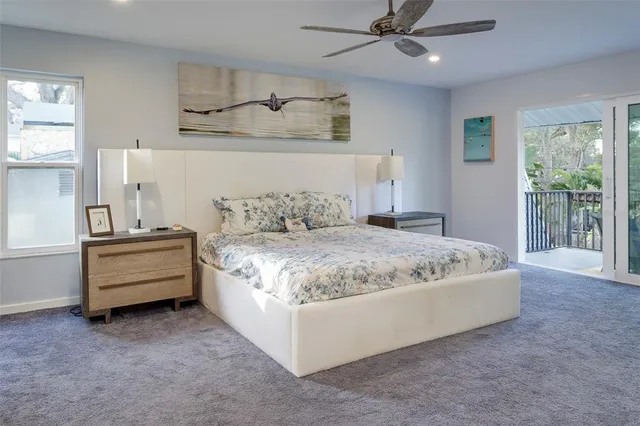 a spacious bedroom with a bed and a window