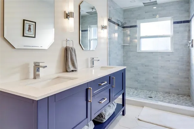a bathroom with a sink double vanity and shower