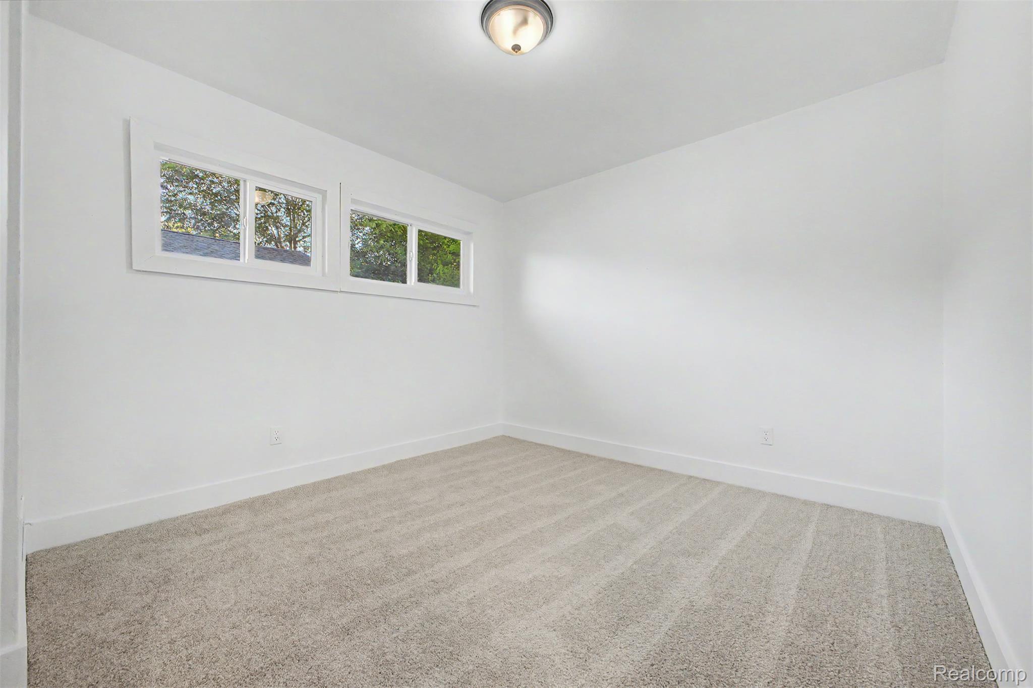 26718 Penn Street Inkster, MI 48141 - Photo 15 of 27 Bright interior room featuring white walls, light-toned carpeting, and a flush-mount ceiling light fixture
