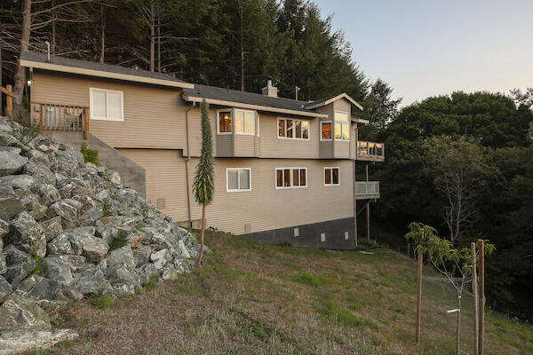 1050 Spring Road Shelter Cove, CA 95589 - Photo 6 of 42 a house with trees in the background