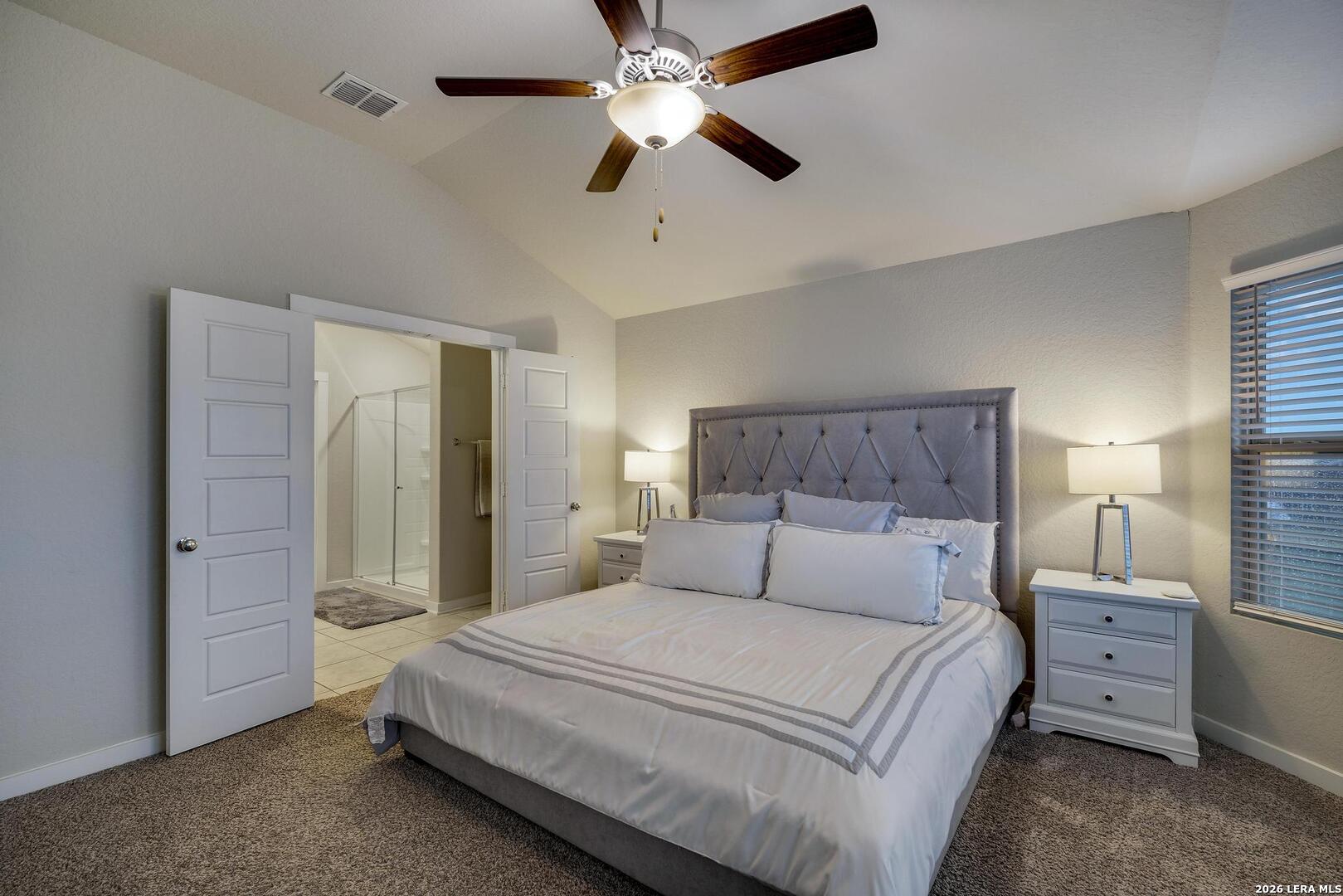 6910 Shiraz Way Converse, TX 78109 - Photo 13 of 25 a bedroom with a bed and a chandelier