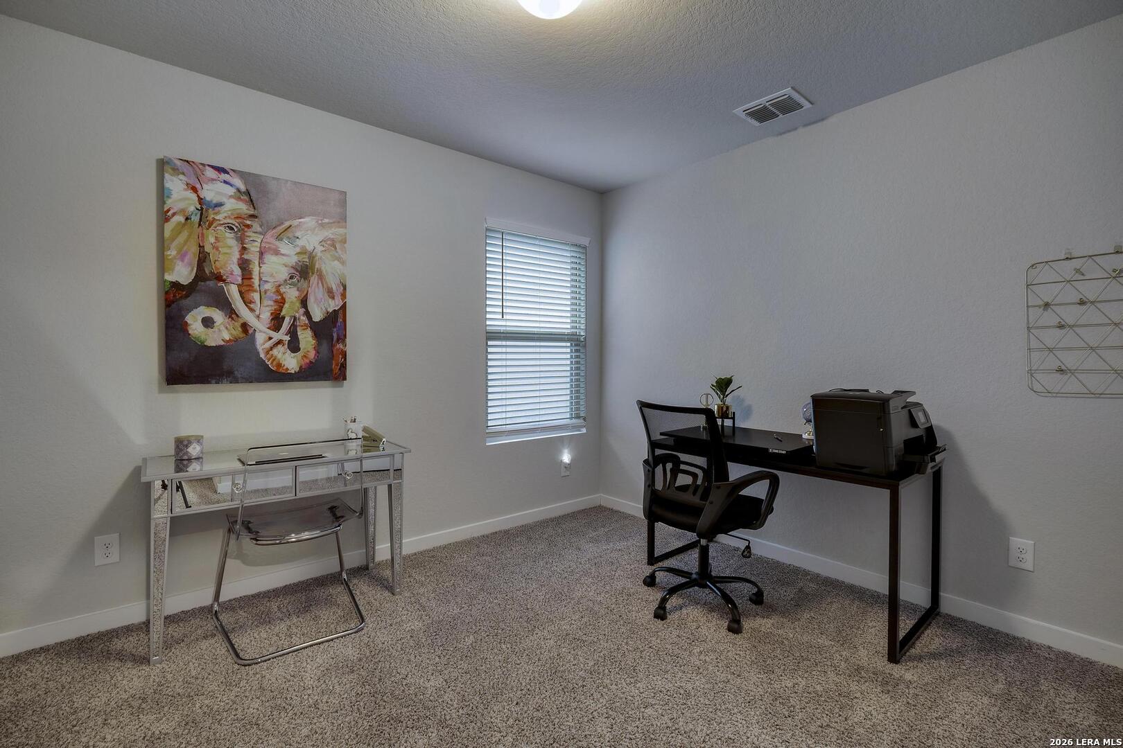 6910 Shiraz Way Converse, TX 78109 - Photo 19 of 25 a view of a workspace with furniture and a window