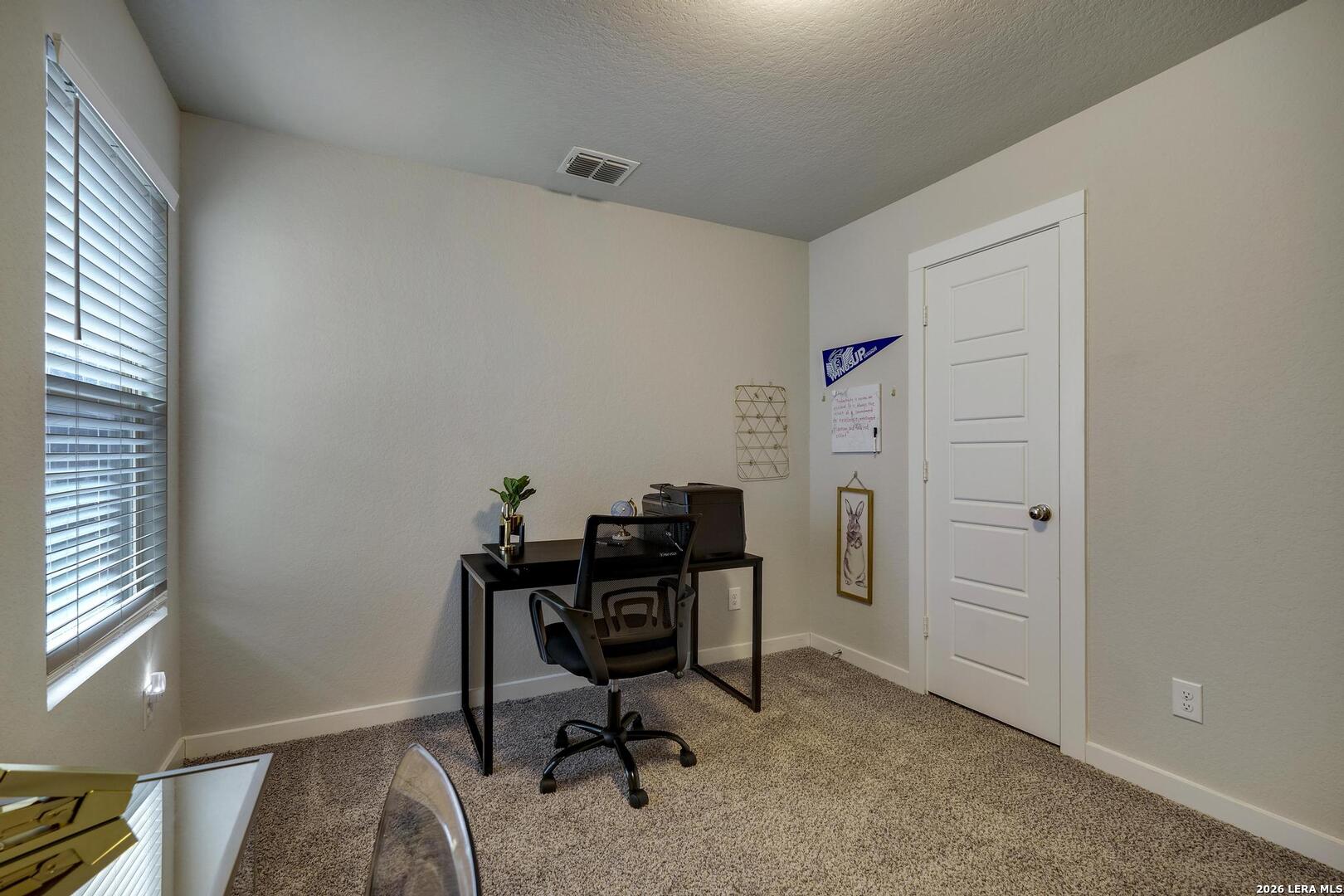 6910 Shiraz Way Converse, TX 78109 - Photo 20 of 25 a view of a workspace with furniture and a window
