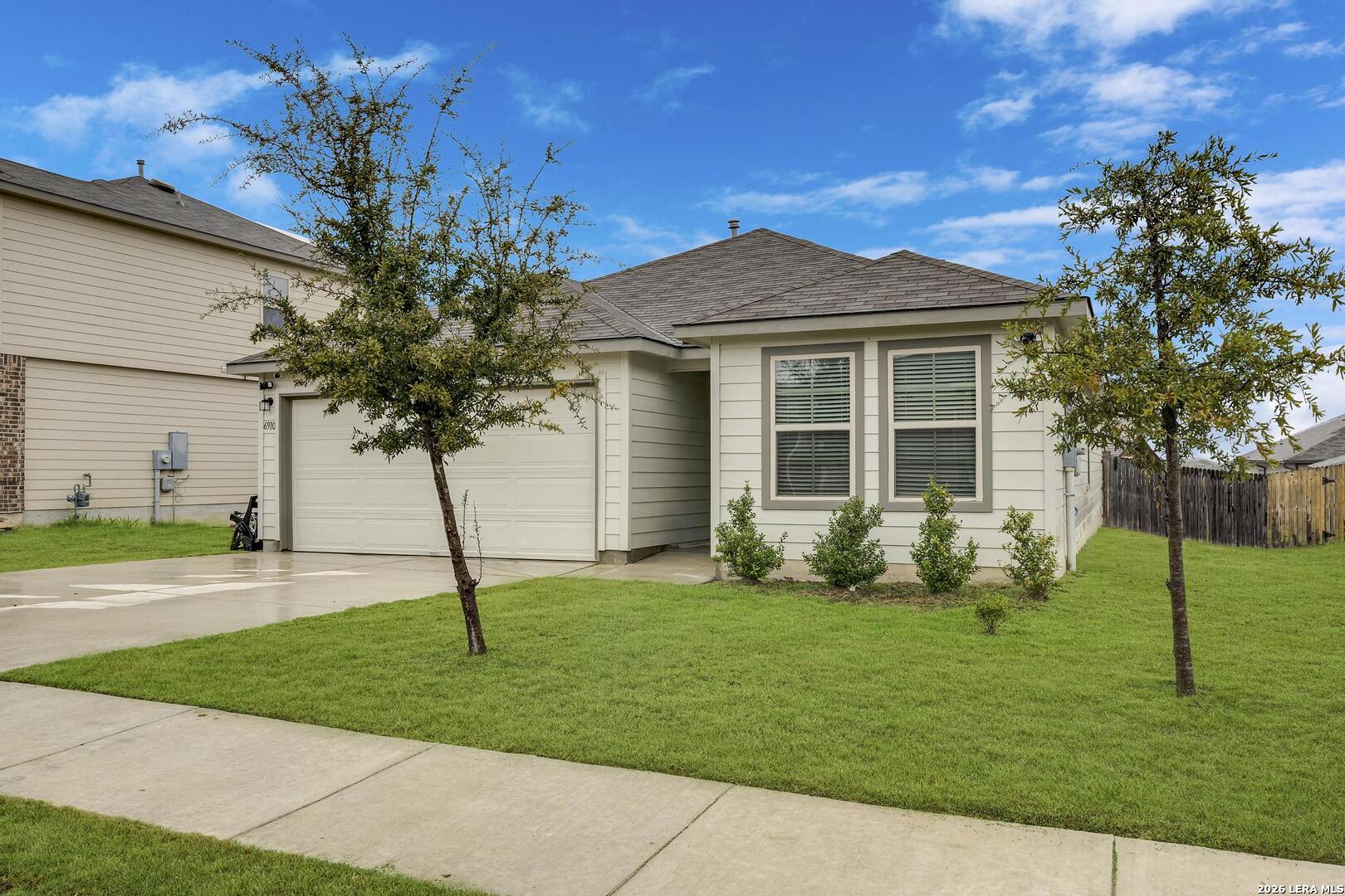 6910 Shiraz Way Converse, TX 78109 - Photo 2 of 25 a front view of a house with a garden