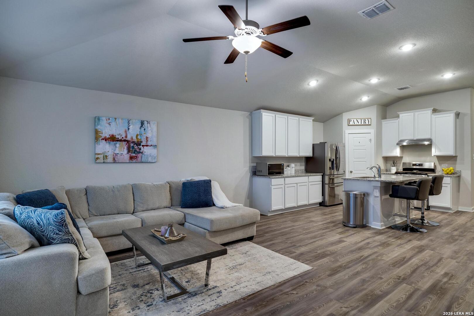 6910 Shiraz Way Converse, TX 78109 - Photo 4 of 25 a living room with furniture and kitchen view