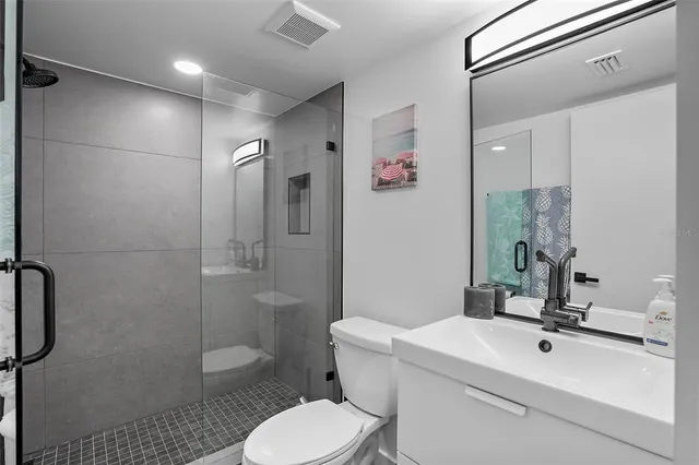 a bathroom with a sink toilet and shower