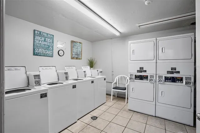 a kitchen with cabinets and chairs